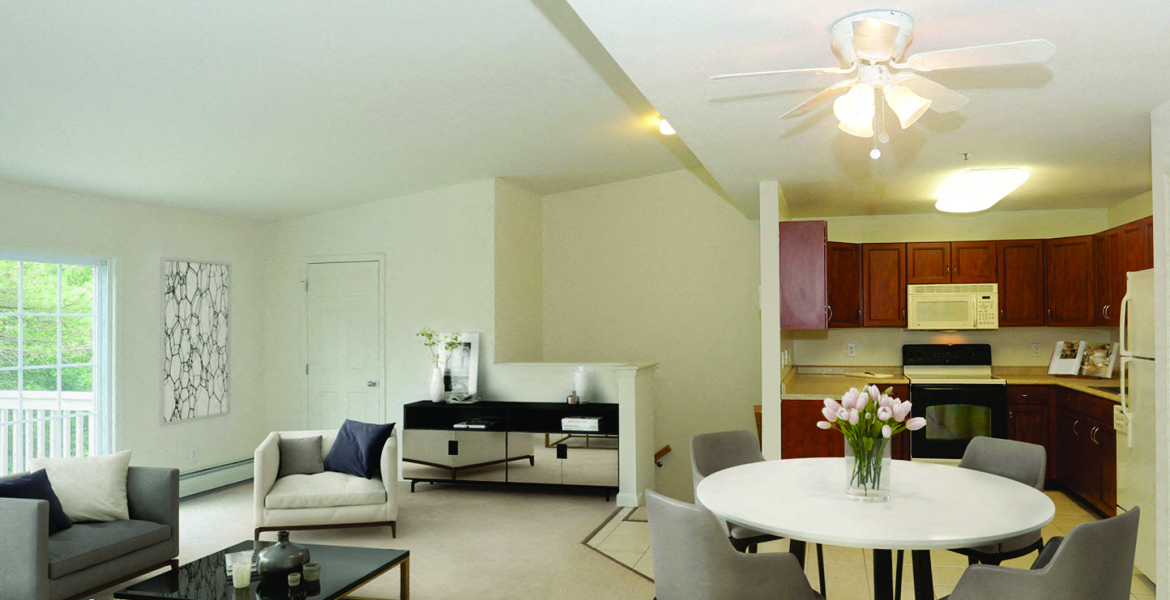 a living room and kitchen with a white table and chairs