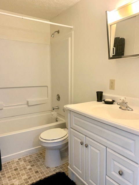 a white bathroom with a sink and a toilet