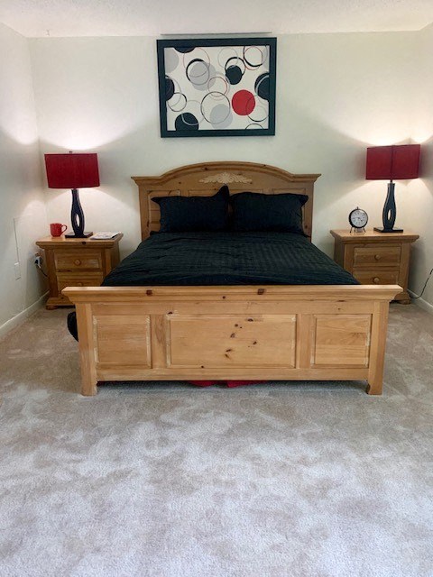 a bedroom with a bed and two lamps