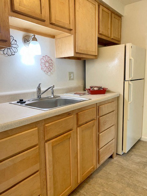 a kitchen with a sink and a refrigerator