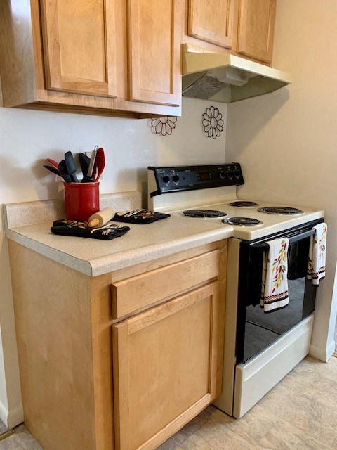 a small kitchen with a stove and a microwave