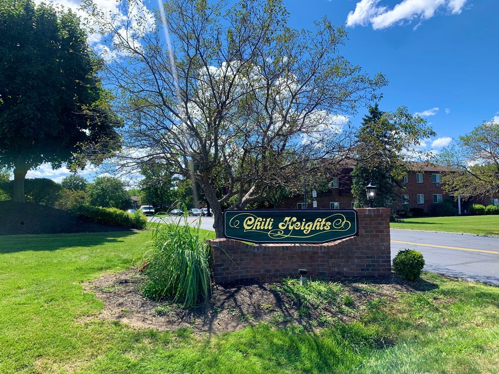 a sign for bell heights in front of a tree