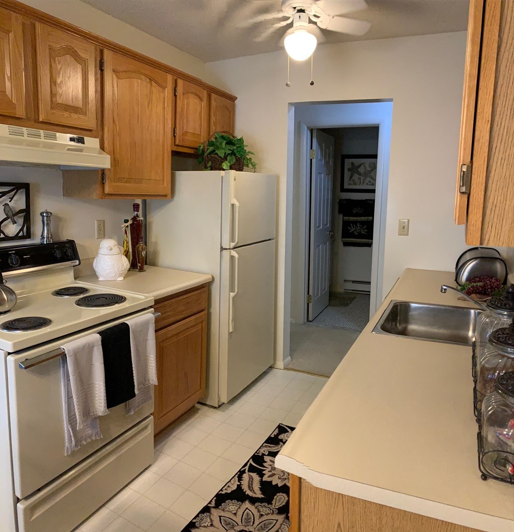 a kitchen with stainless steel appliances and wooden cabinets