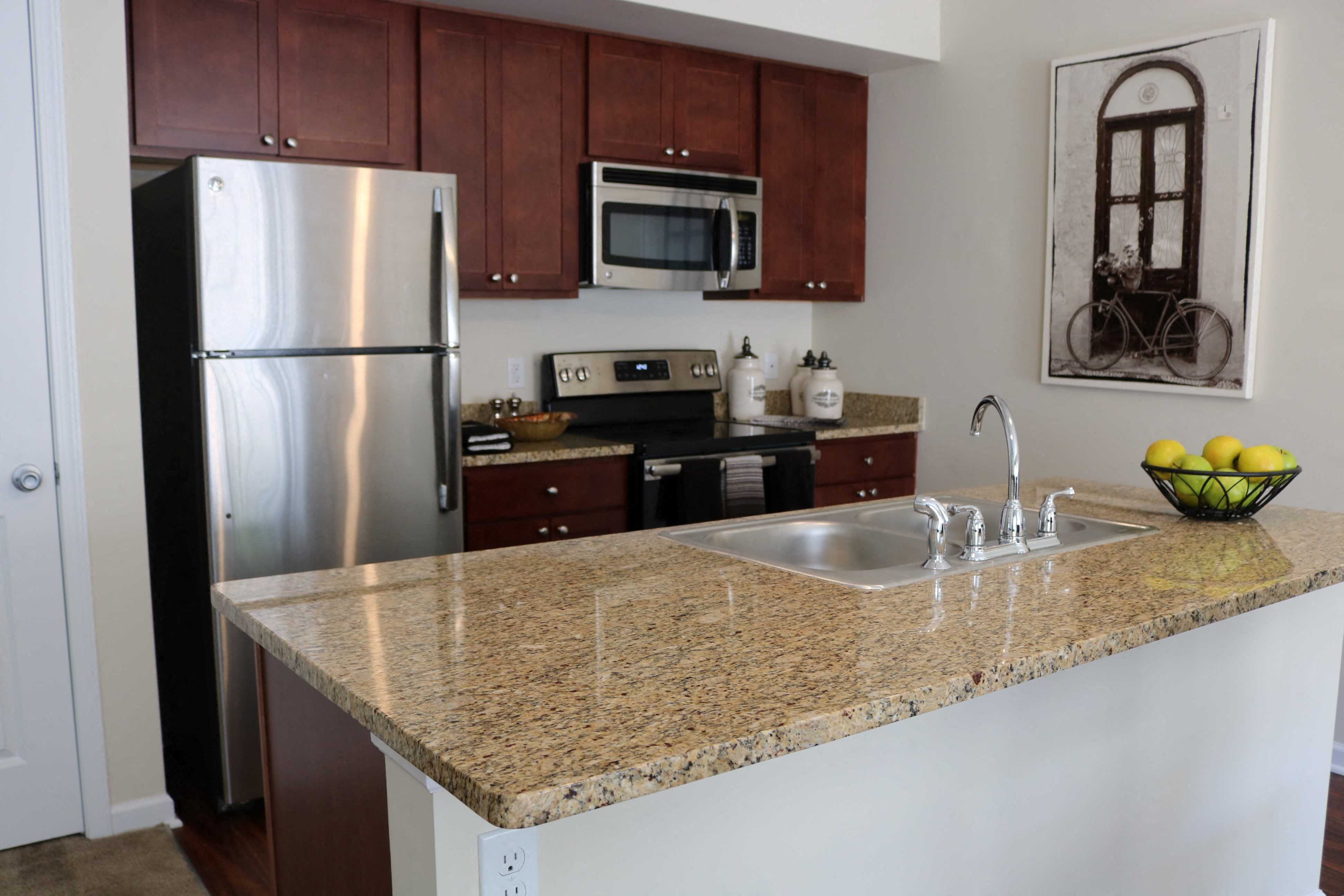 a kitchen with granite counter top and stainless steel appliances