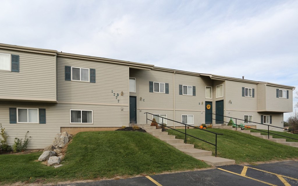 Building Exterior with Green Lawn at Stone Hedge Village Townhouses, Farmington, NY 
