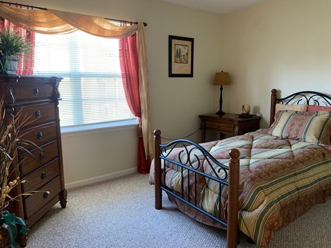 a bedroom with a bed and a dresser