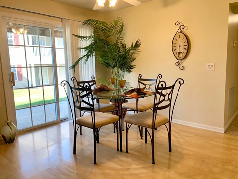 a dining room with a table and chairs and a window