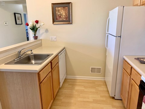 a kitchen with a sink and a refrigerator