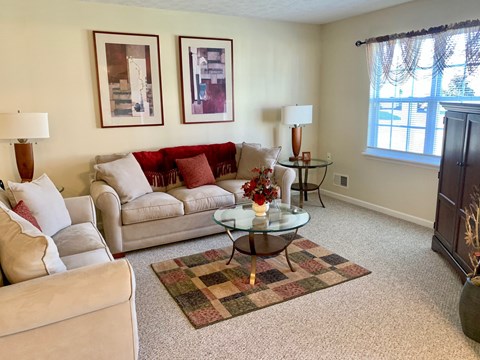 a living room with couches and a coffee table