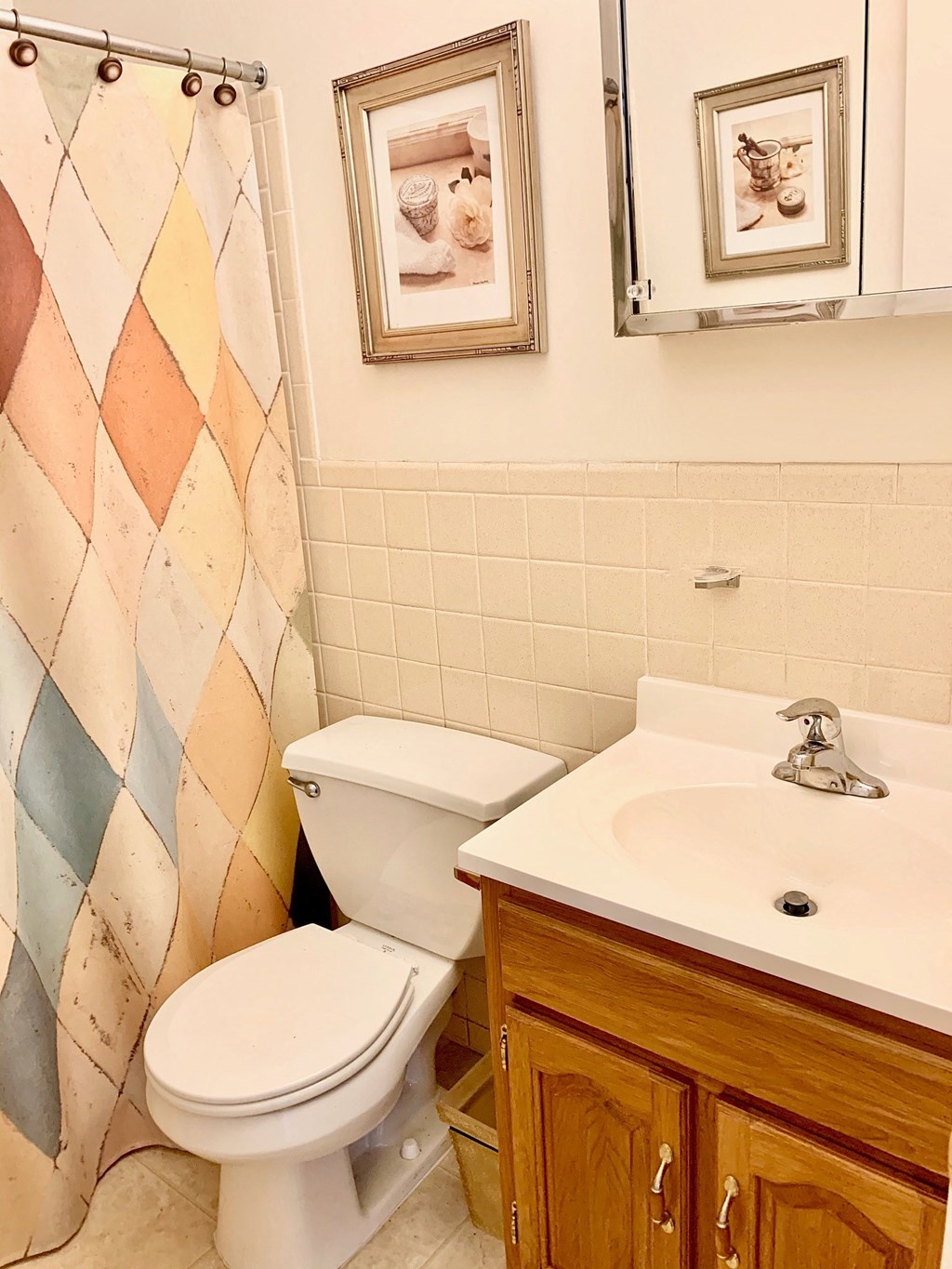 a bathroom with a toilet and a sink and a shower curtain