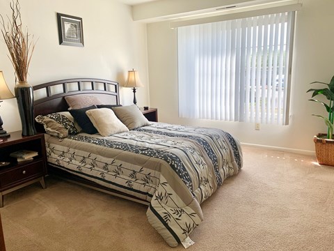 a bedroom with a bed and a window