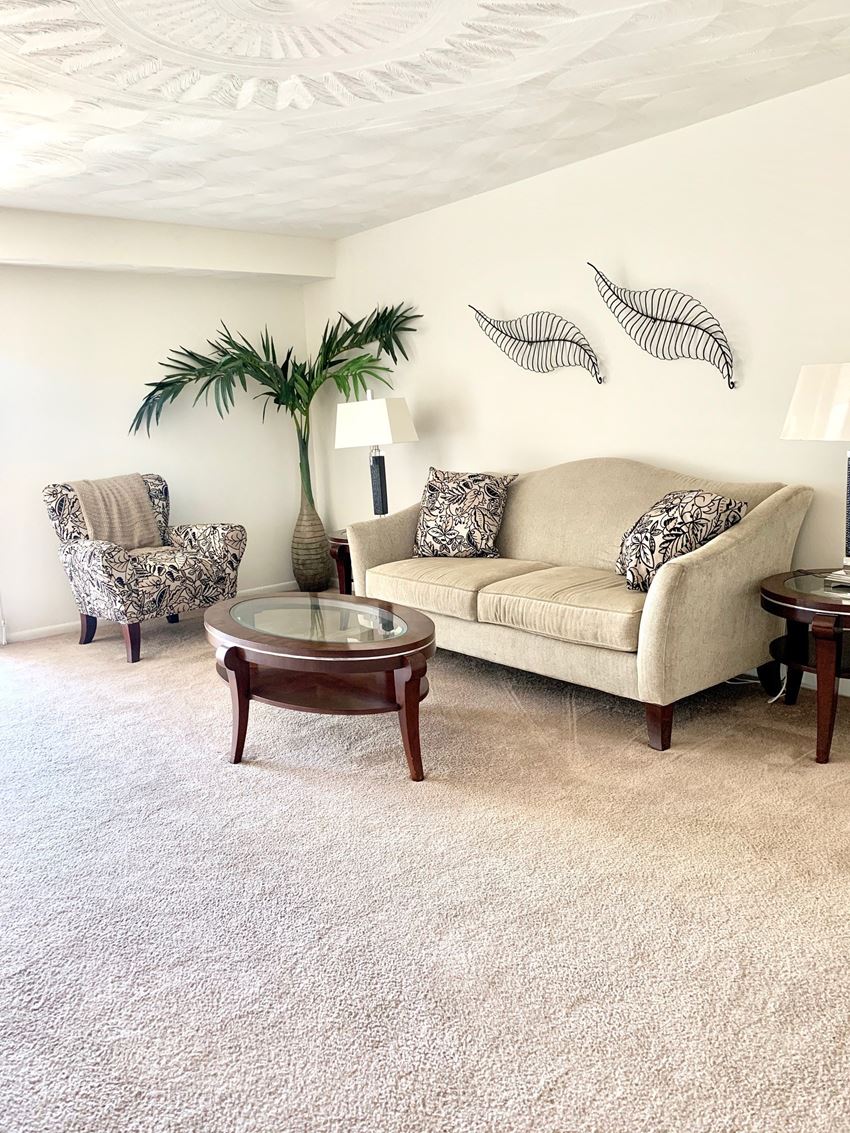 a living room with a couch and two chairs