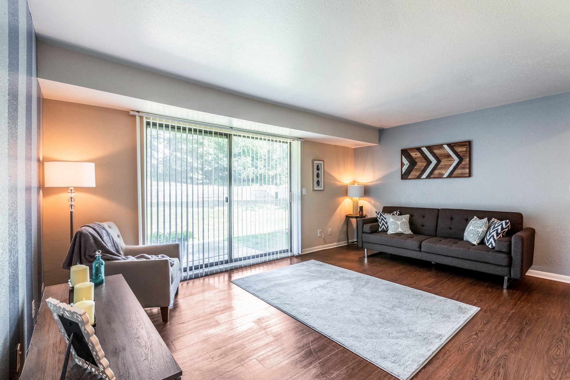 A living room with a couch, chair, and table.