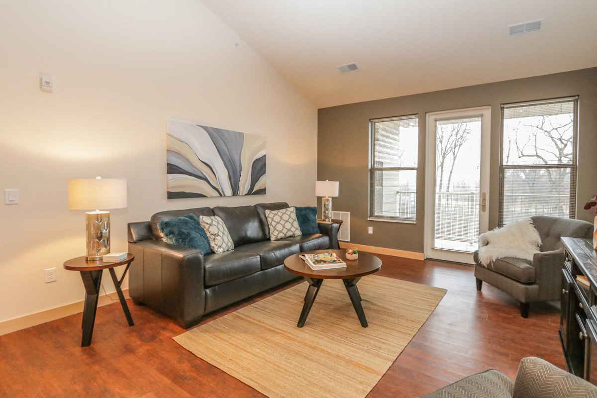 a living room with a couch and a chair and a table