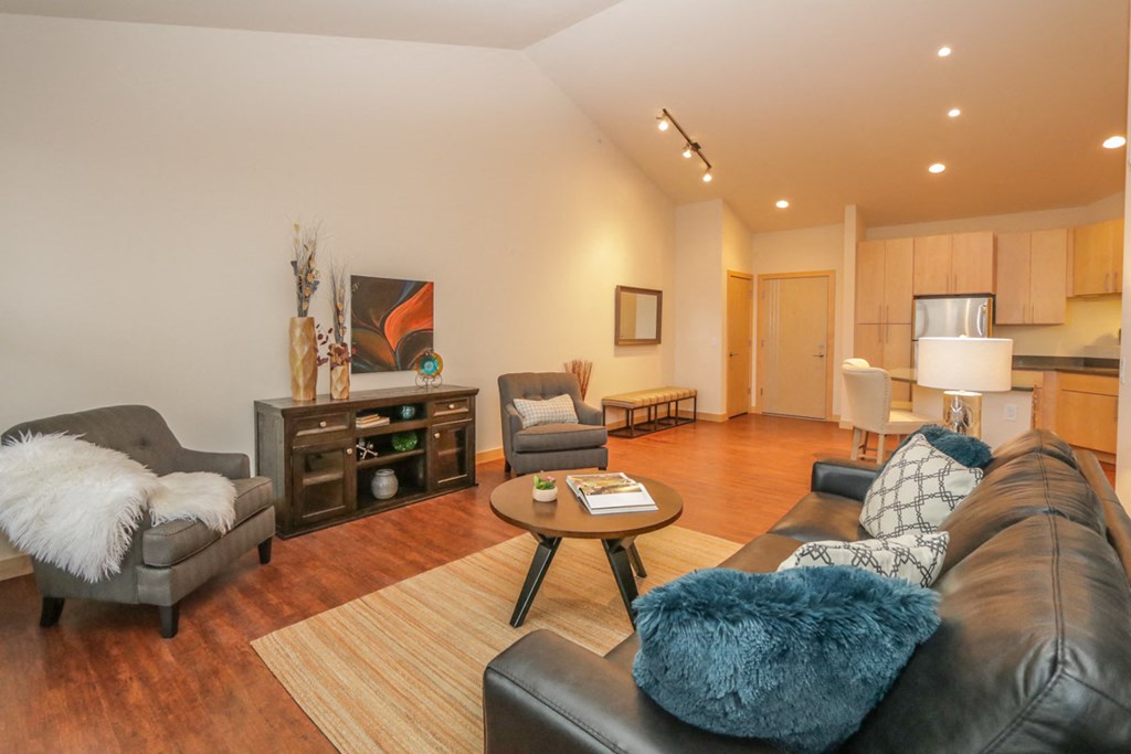 a living room with a leather couch and chairs