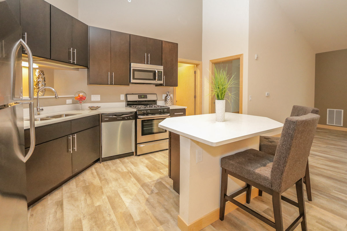 a kitchen with stainless steel appliances and a white counter top