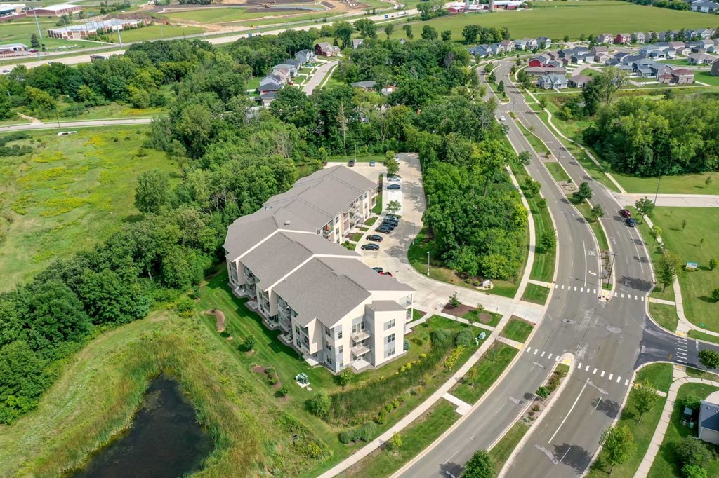 an aerial view of a building with a road around it