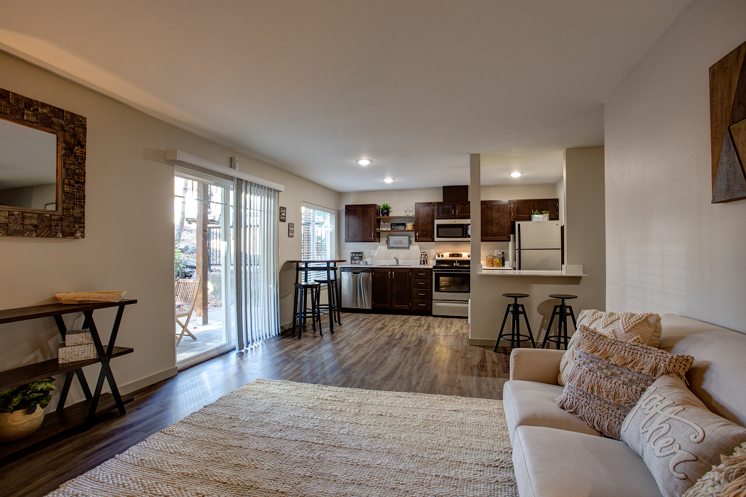 a living room with a couch and a kitchen