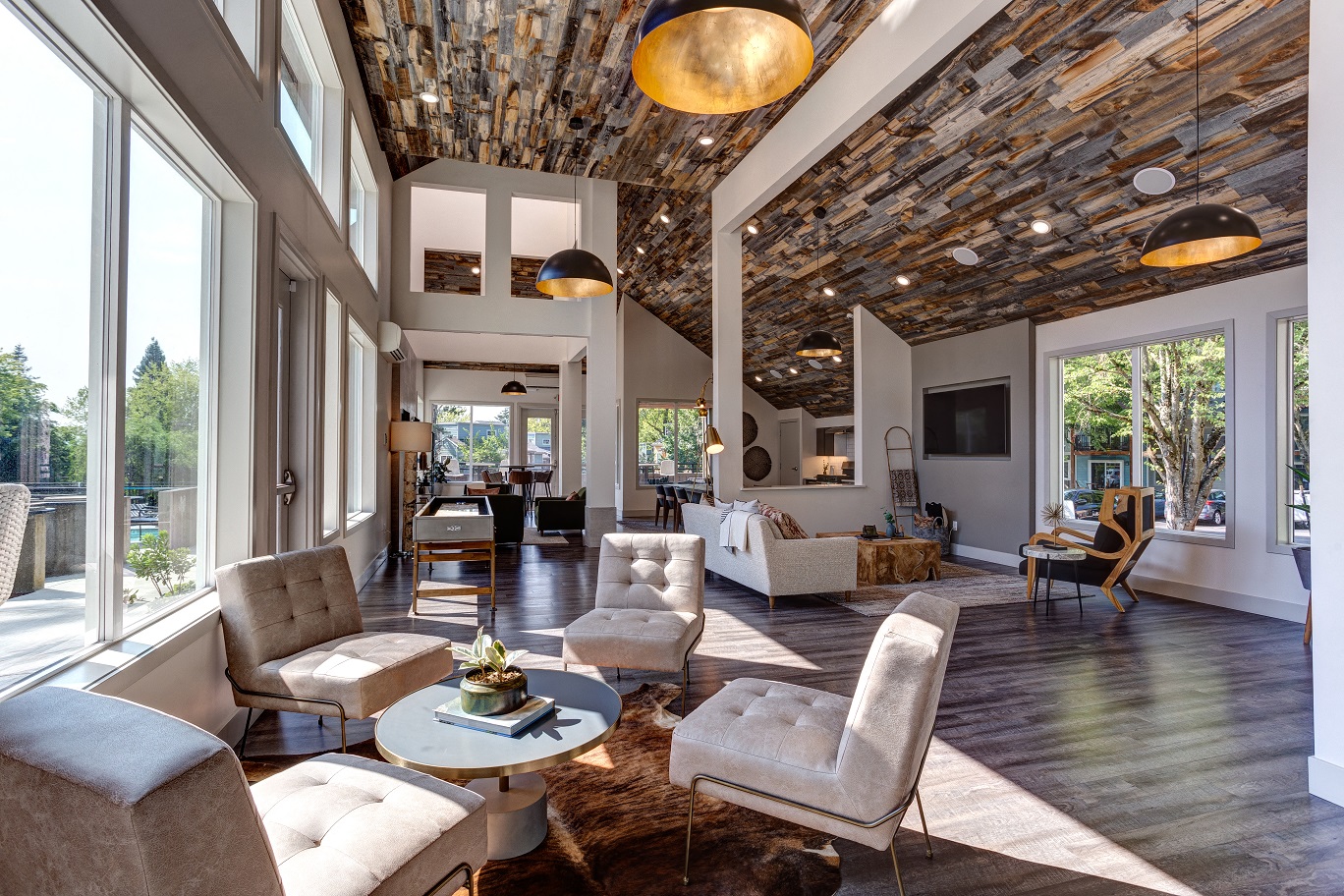 a living room with couches and chairs and a large window