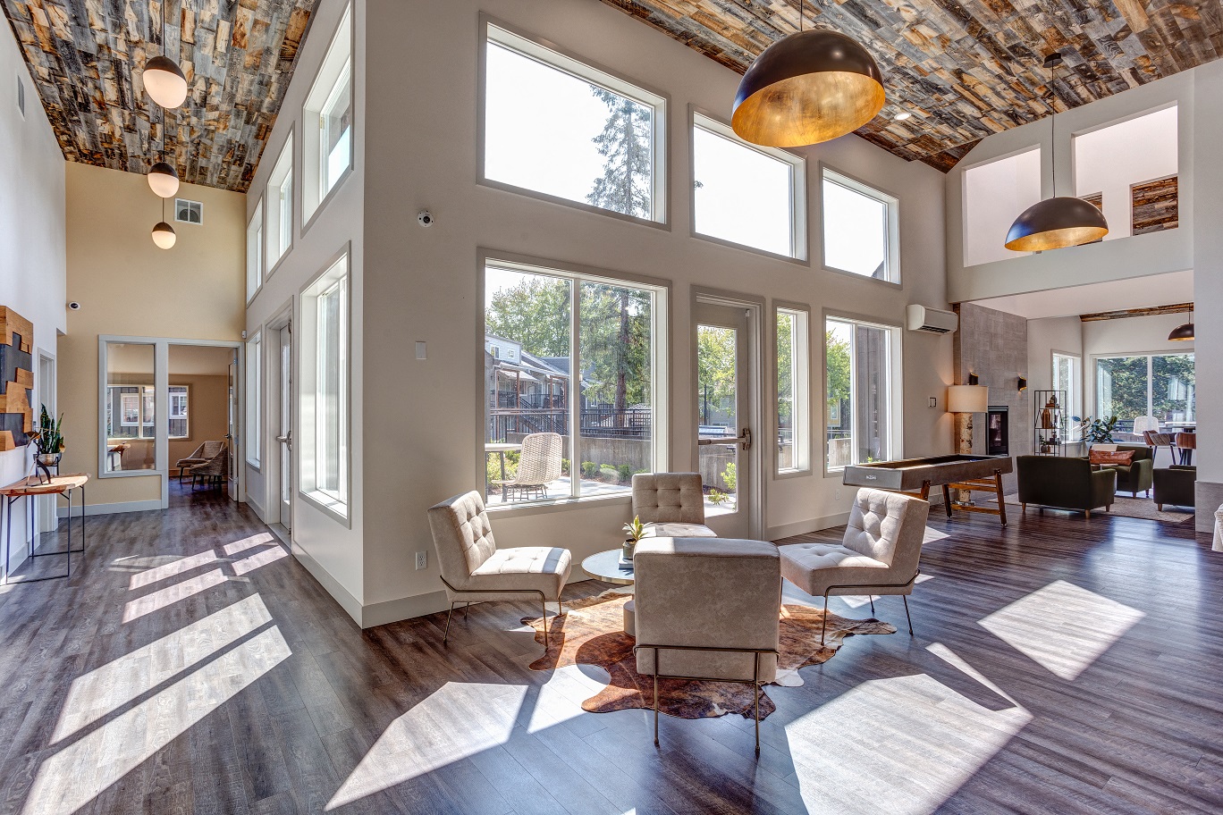 an open living room with large windows and furniture