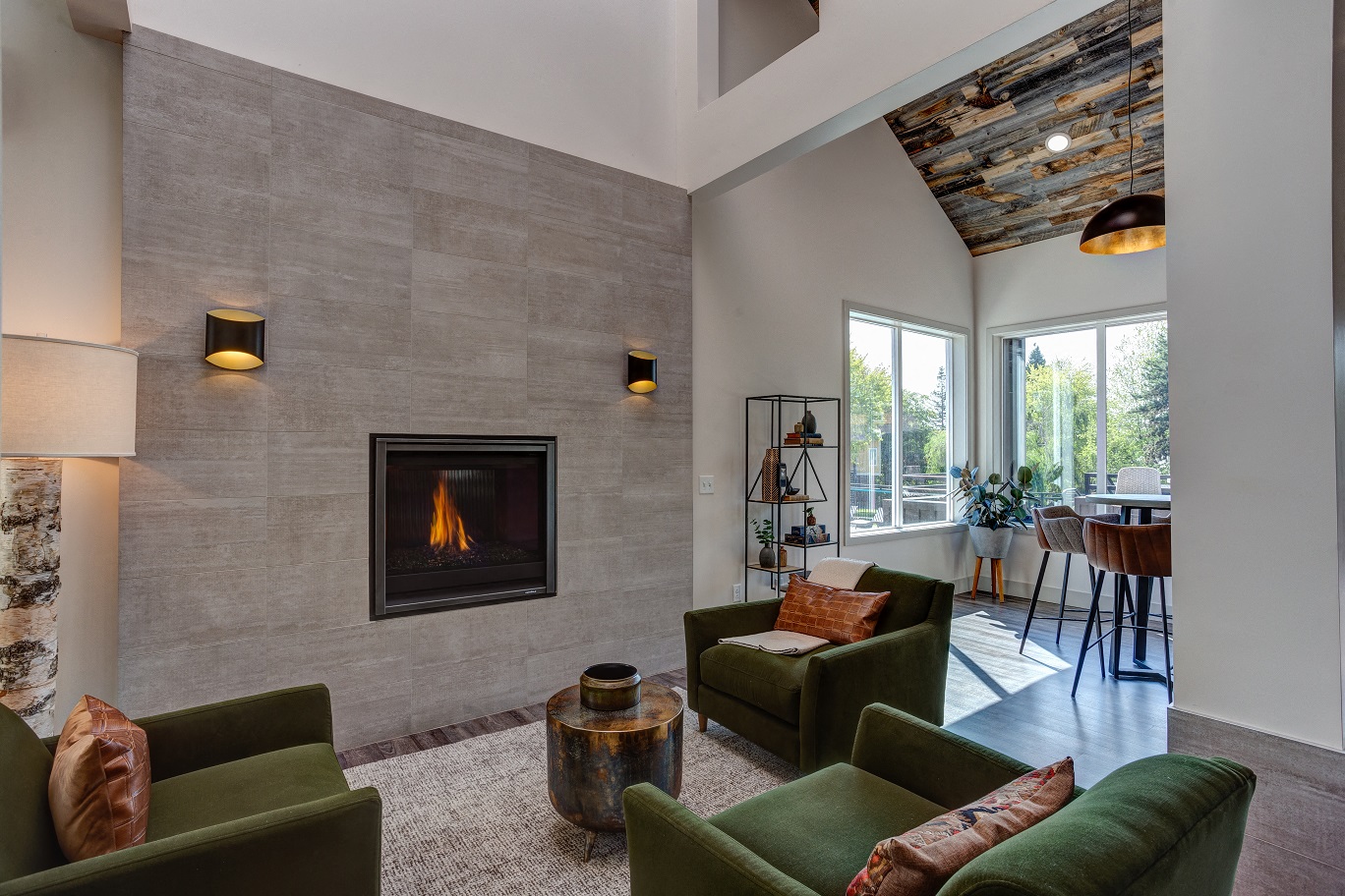 a living room with green couches and a fireplace