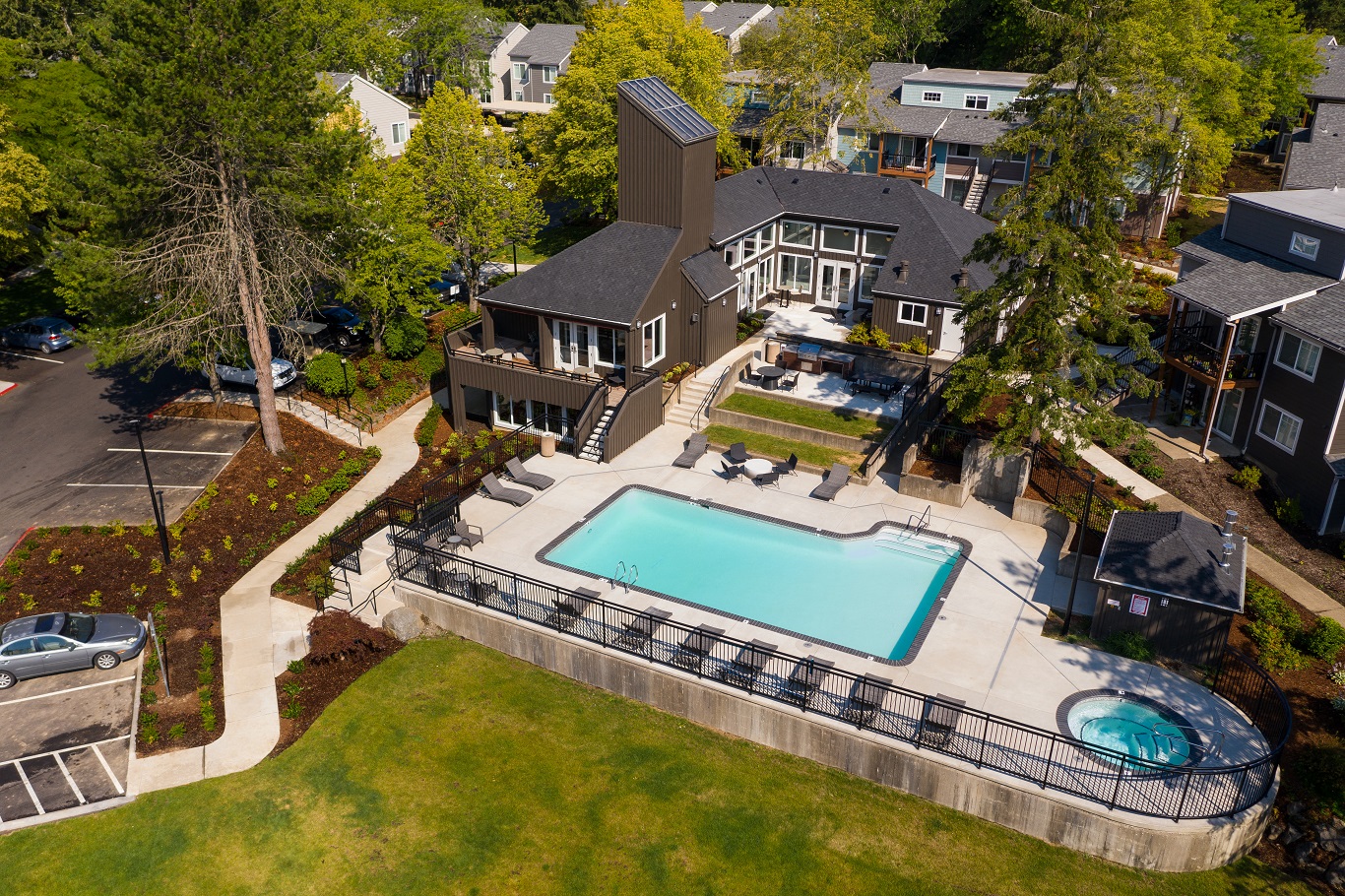 an aerial view of a swimming pool in front of a house