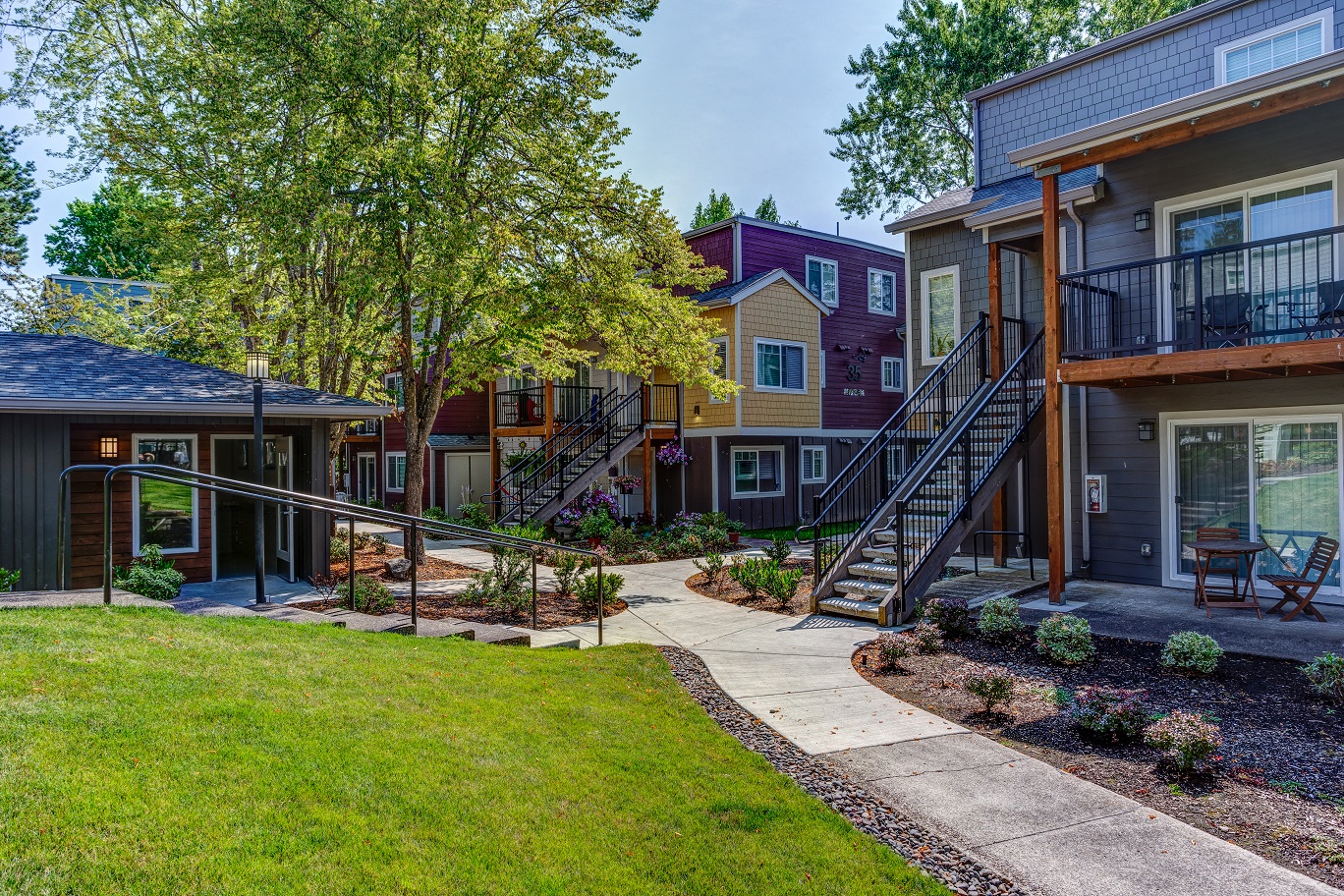 a sidewalk in front of a row of houses