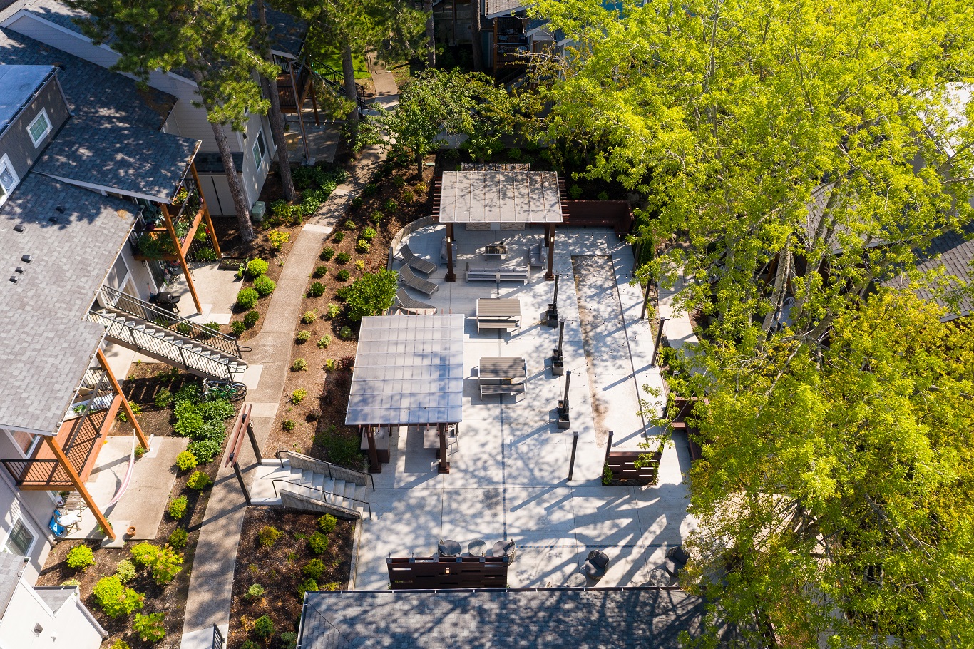 a birds eye view of the backyard of a house with a courtyard and trees