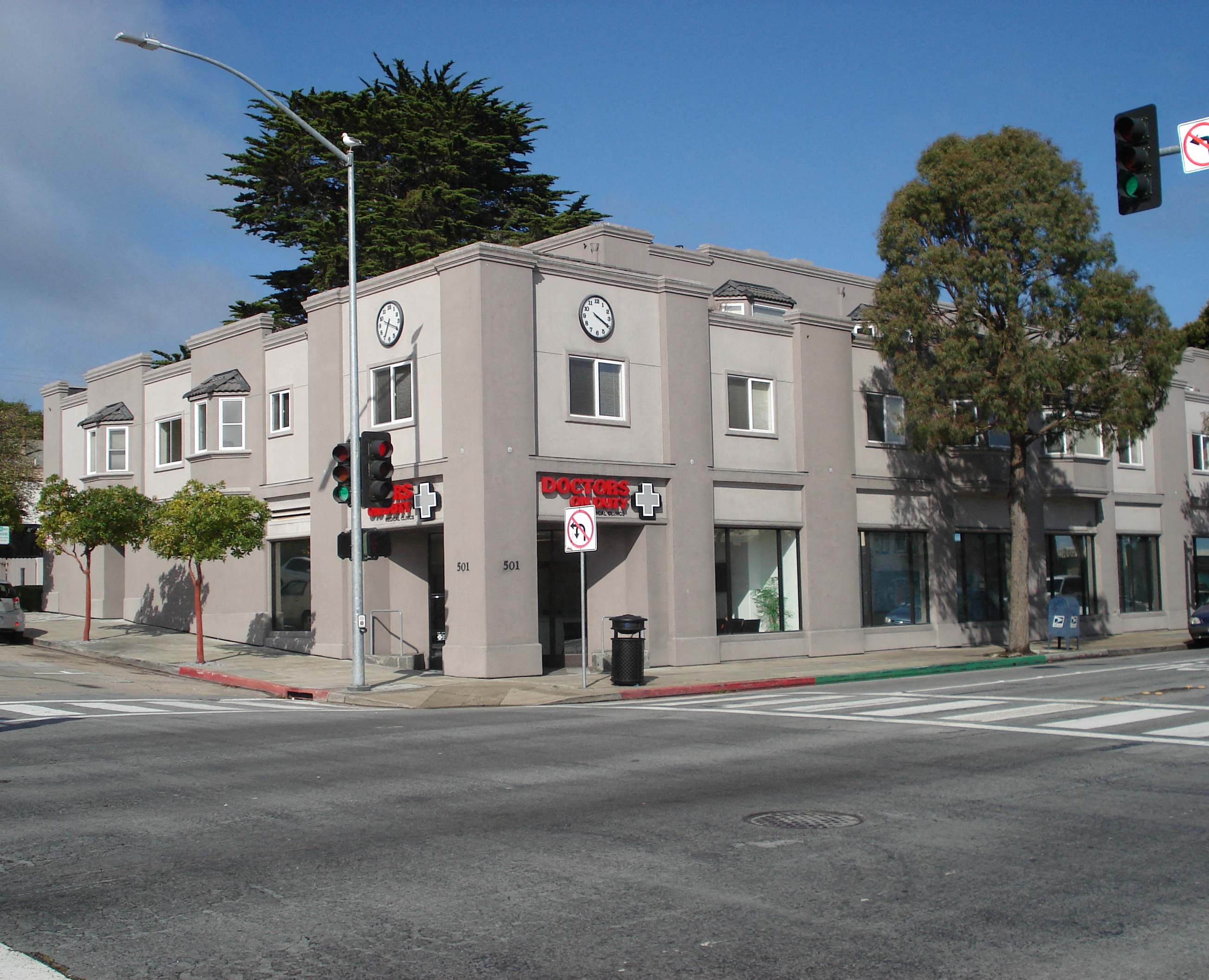 a building on the corner of a street with a traffic light
