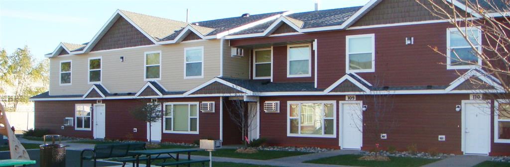a red house with a table in front of it