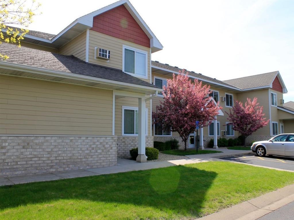 a house with a lawn and a tree in front of it