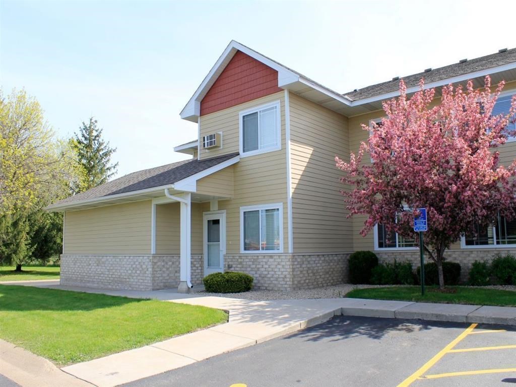 a yellow house with a flowering tree in front of it