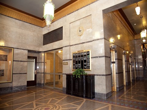 a view of the lobby of a building with doors and a clock