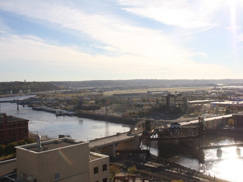 a view of a bridge over a river with a city in the background