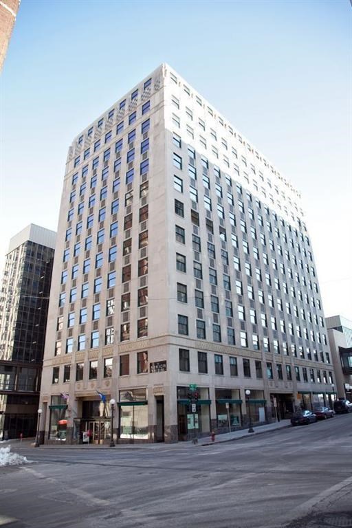 a tall building on the corner of a city street