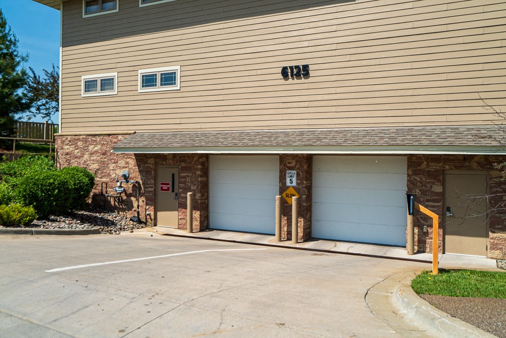 the front of a building with two garage doors