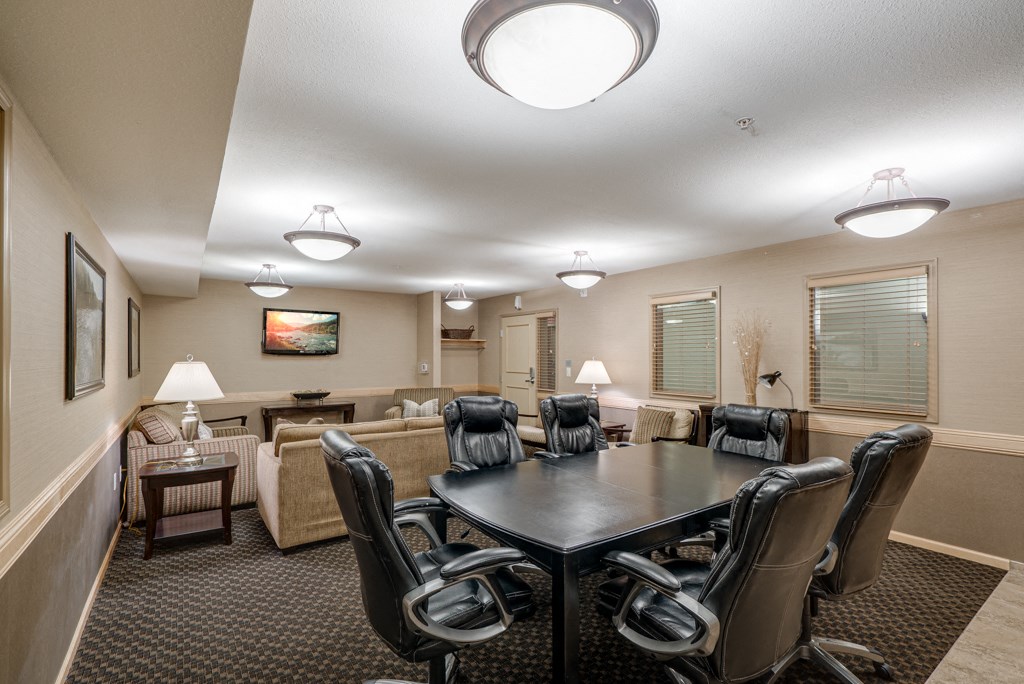 a conference room with a table and chairs and a couch