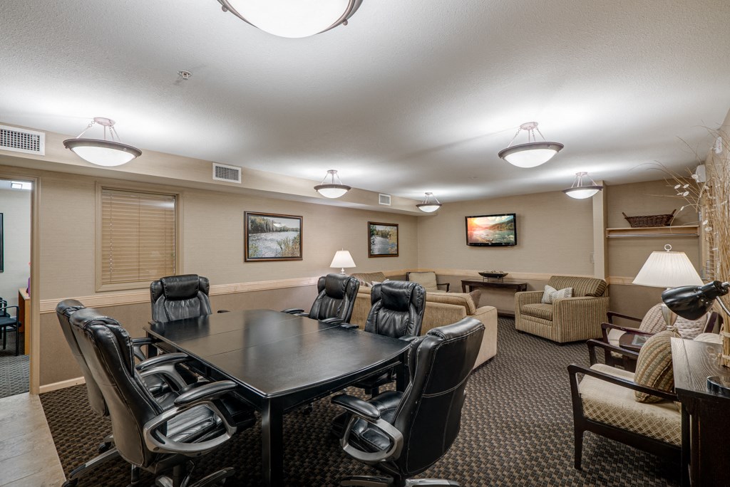 a conference room with a table and chairs