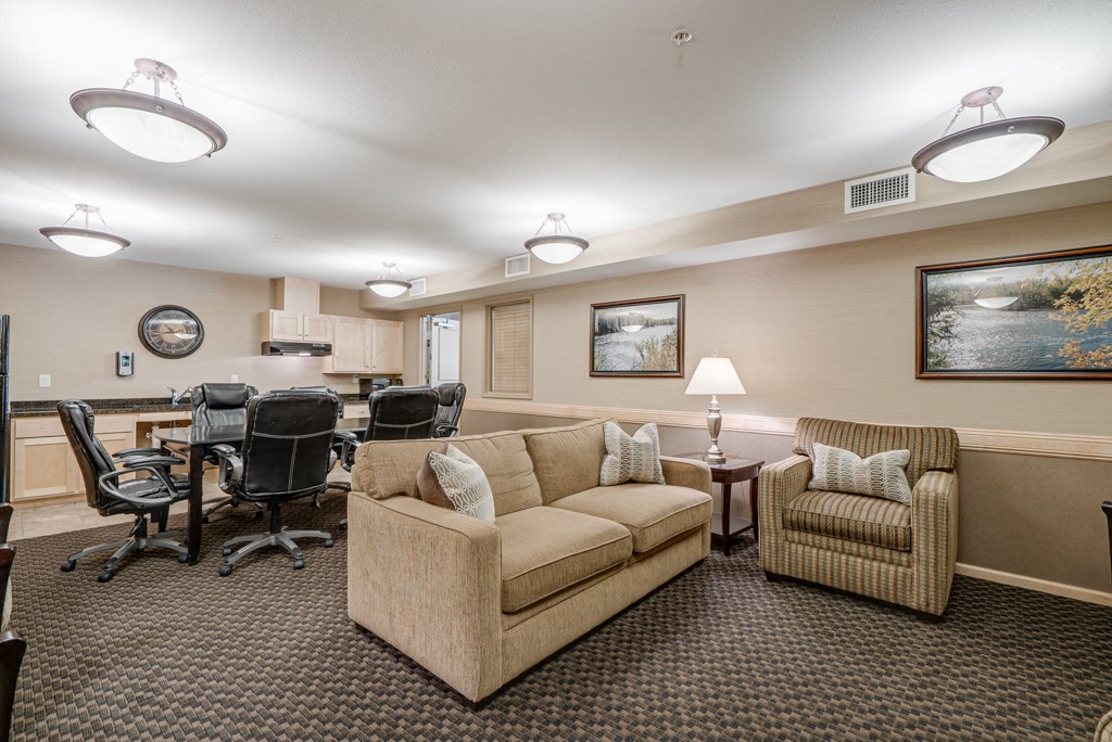 a living room with couches and chairs and a table