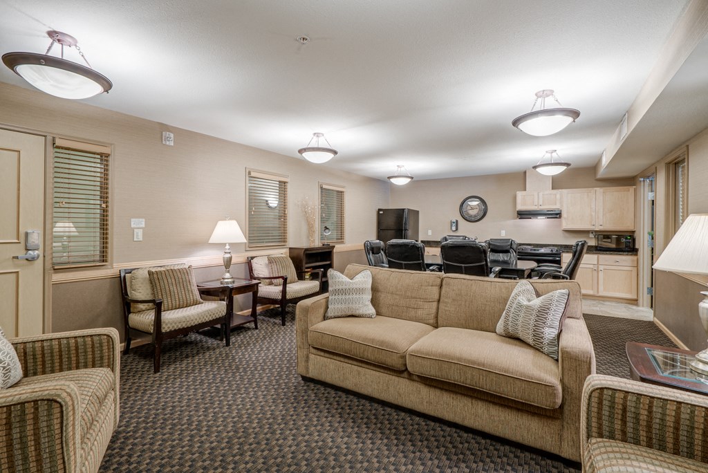 a living room with couches and chairs and a dining room table