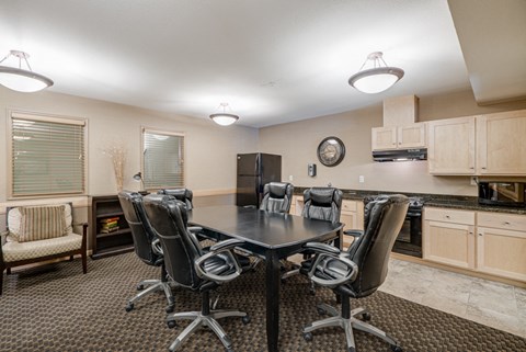a kitchen and dining room with a table and chairs