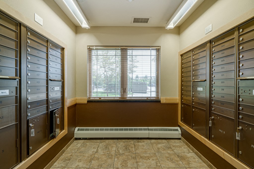 the mail room at the community center with mailboxes and window
