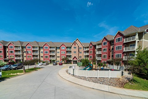 a row of colorful apartment buildings with a playground in front of them