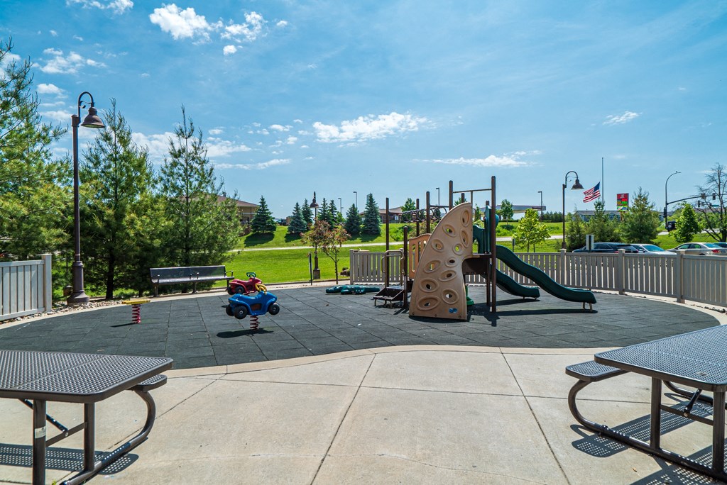 a child on a swing at a playground at a park