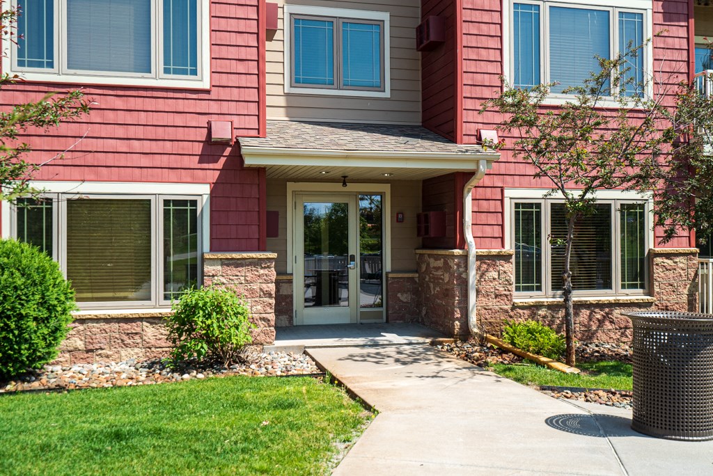 a red house with a sidewalk in front of it