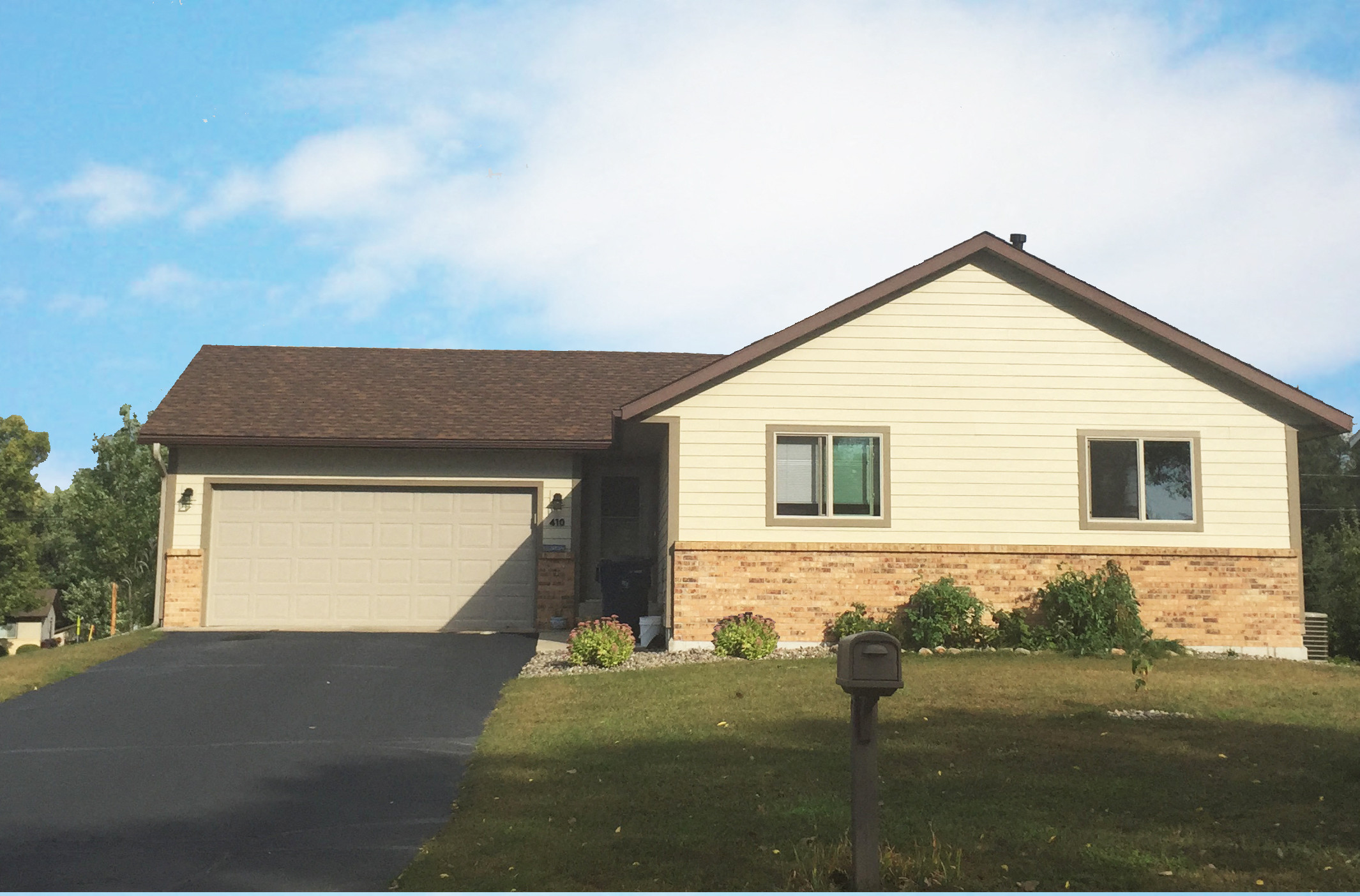 a house with a driveway and a garage door
