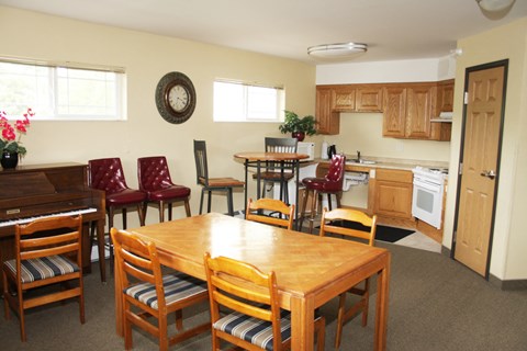 A kitchen with a table and chairs in the middle of the room.