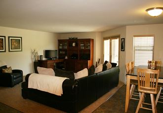 a living room with a couch and a dining room table