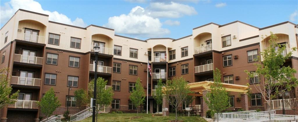 an apartment building with trees in front of it