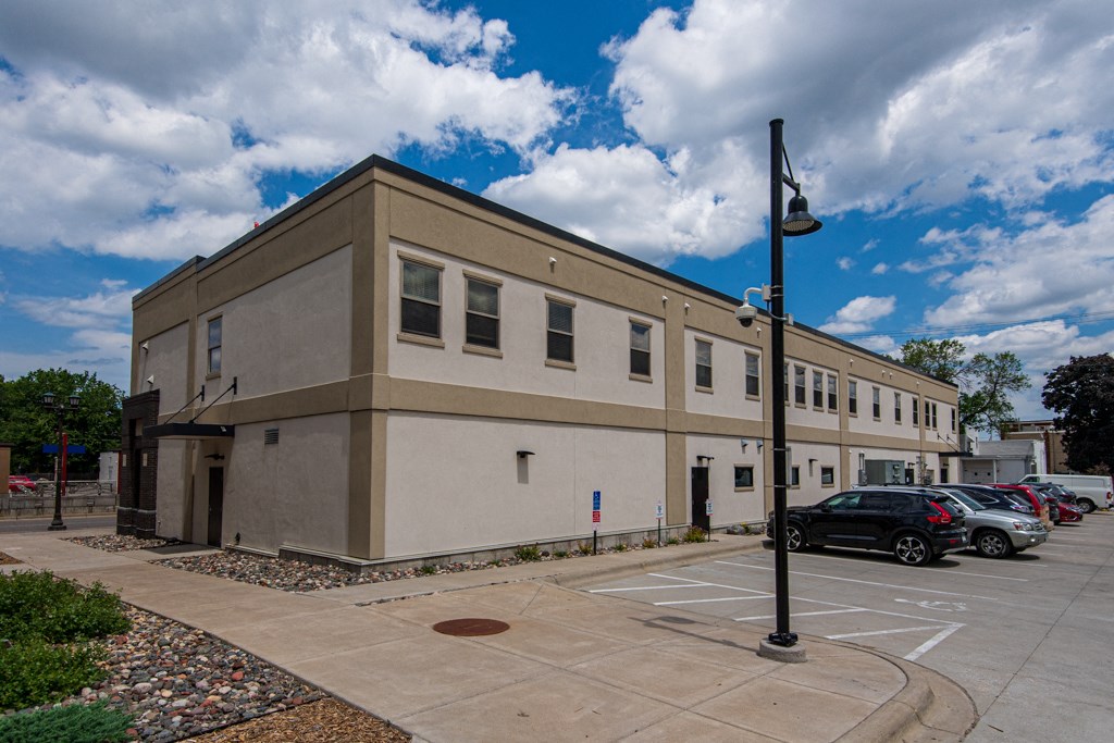 a large building with cars parked in a parking lot